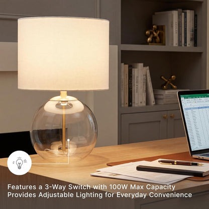 Signature Design by Ashley Glass Table Lamp, Modern Bedside, Clear & Brass | White Fabric Drum Shade, Compact round Clear Glass Profile for Modern Nightstands, Samder Series5