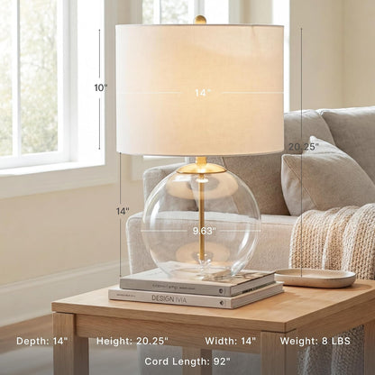 Signature Design by Ashley Glass Table Lamp, Modern Bedside, Clear & Brass | White Fabric Drum Shade, Compact round Clear Glass Profile for Modern Nightstands, Samder Series2