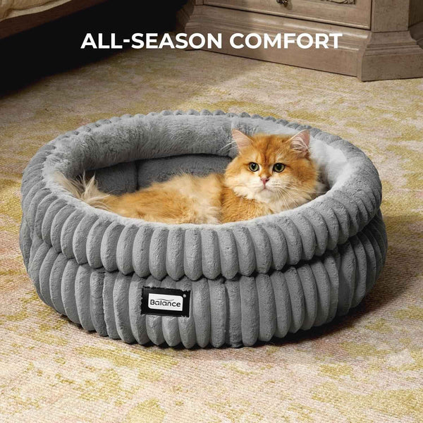 Fluffy orange cat resting in cozy gray corduroy pet bed for all-season comfort4