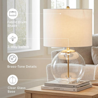 Signature Design by Ashley Glass Table Lamp, Modern Bedside, Clear & Brass | White Fabric Drum Shade, Compact round Clear Glass Profile for Modern Nightstands, Samder Series6