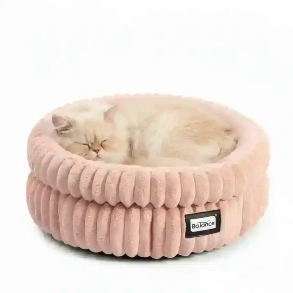 Fluffy cat sleeping in cozy pink corduroy pet bed with Balance tag7